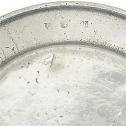 Collection of early 19th century and later British pewter, mostly London label marks, including two large pewter chargers, medicine spoon, flasks, plates and other tableware