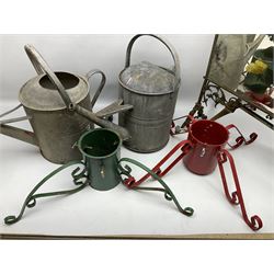 Two mirrored brass fire screens, together with two christmas tree stands and two galvanised watering cans one with a rose head