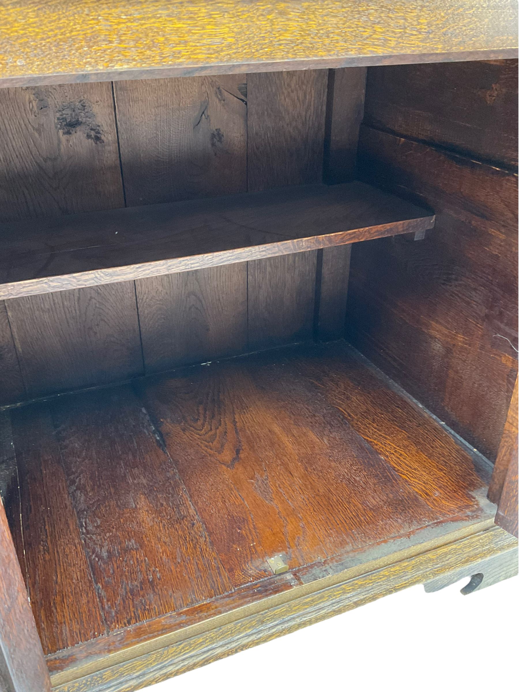 Traditional oak dresser, the moulded cornice over shaped apron, three heights plate rack fitted with two cupboards, the base fitted with six drawers and two double cupboards, panelled pointed ogee arched doors, on bracket feet