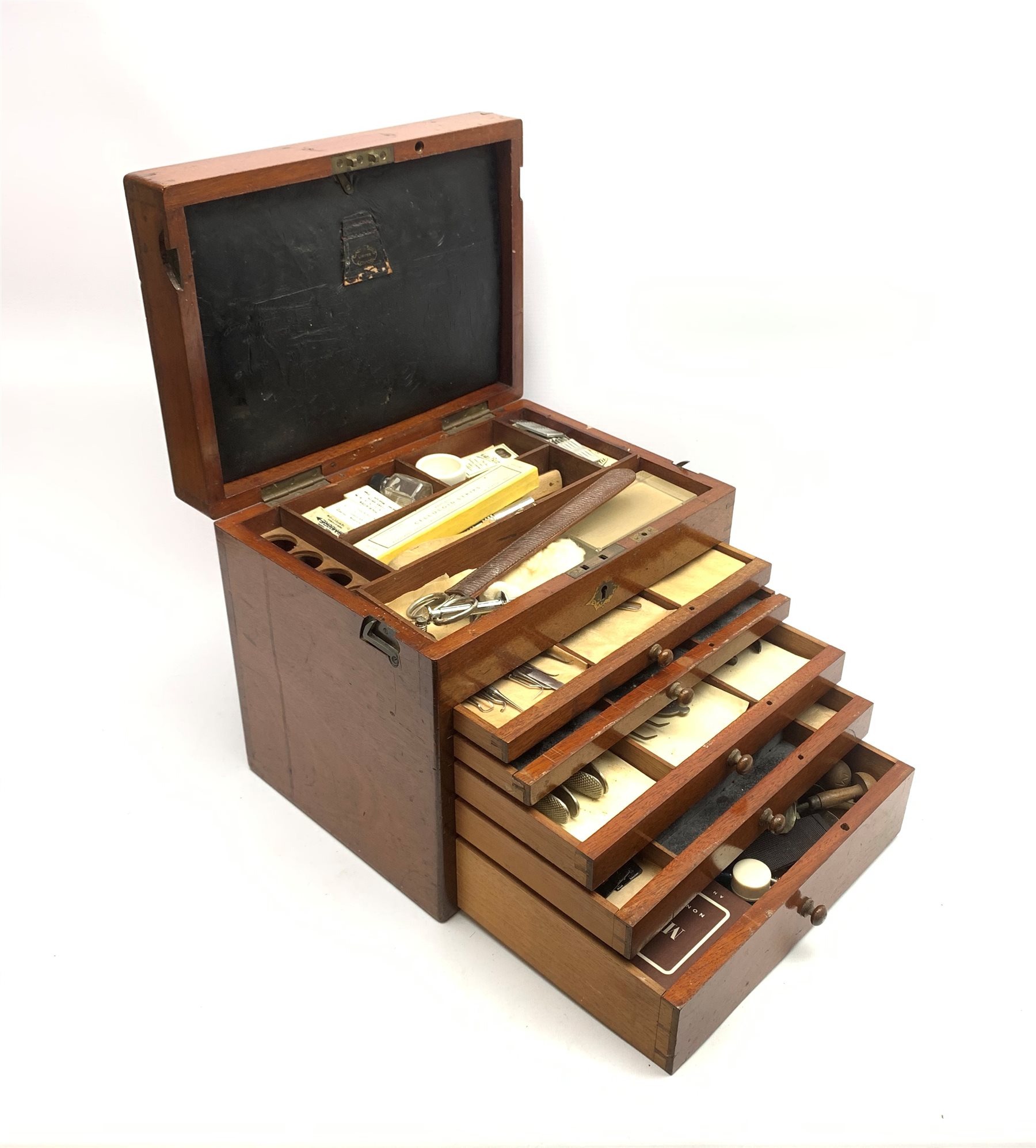  Dentistry - Late Victorian mahogany Dentists cabinet by C. Ash & Co, hinged cover above six long graduated drawers, enclosing a comprehensive arrangement of implements, pharmaceutical bottles, tools, modelling wax, porcelain teeth, 