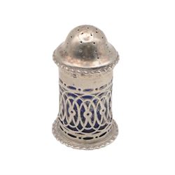 Late Victorian silver three piece cruet set, comprising open salt, pepper pot and mustard pot with cover, all with pierced decoration and upon four bun feet, hallmarked John Charles Lowe, London 1899 and 1900, salt with different maker's mark worn and indistinct, all with blue glass liners