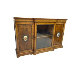 Victorian figured walnut break-front credenza, central glazed door flanked by two panelled doors with Sevres style portrait oval panels, ormolu foliate beading and moulded cartouche escutcheons, on plinth base
