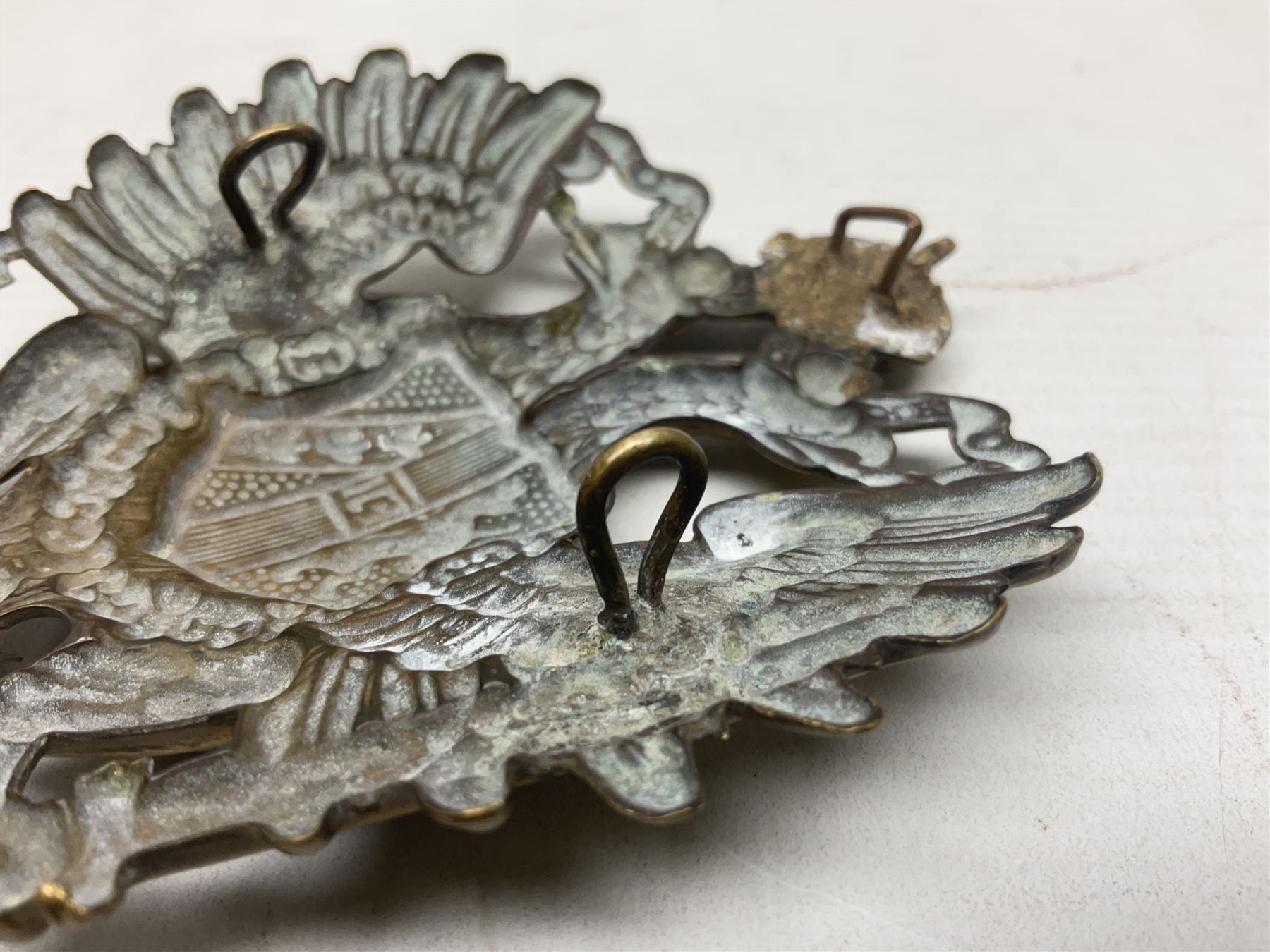 Austrian shako plate 1890 - 1914 with three fixing eyes verso