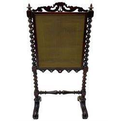Victorian rosewood fire screen, scrolled foliage carved pediment, rectangular frame with moulded gilt slip enclosing figural needlework tapestry panel, on spiral turned supports with finials united by turned lower stretcher, on out-splayed feet with scroll carved terminals 