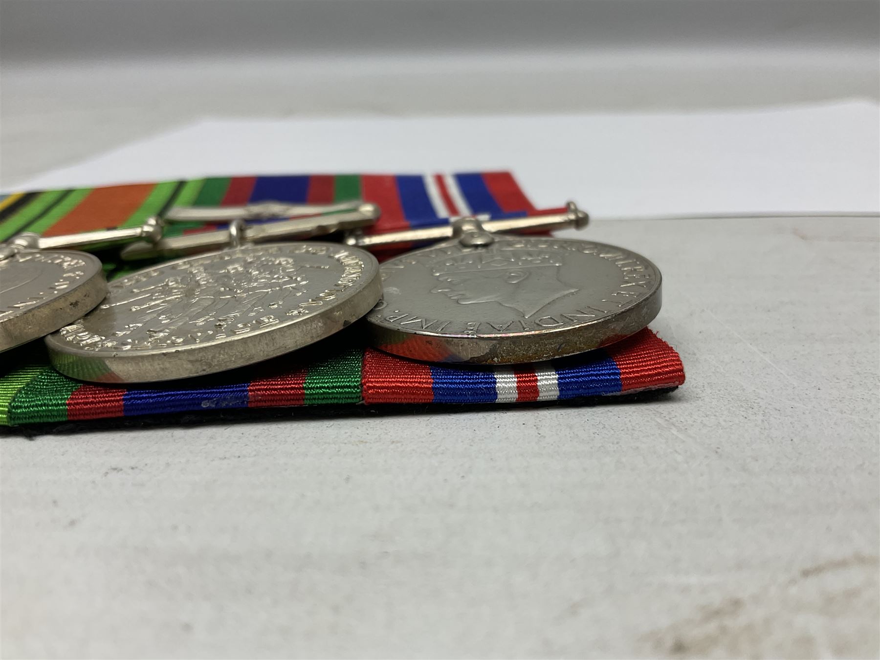 Group of five medals comprising 1939-1945 War Medal, Defence Medal, 1939-1945 Star, Air Crew Europe Star and Canadian Volunteer Service Medal with maple leaf clasp; all with ribbons and mounted on a display board