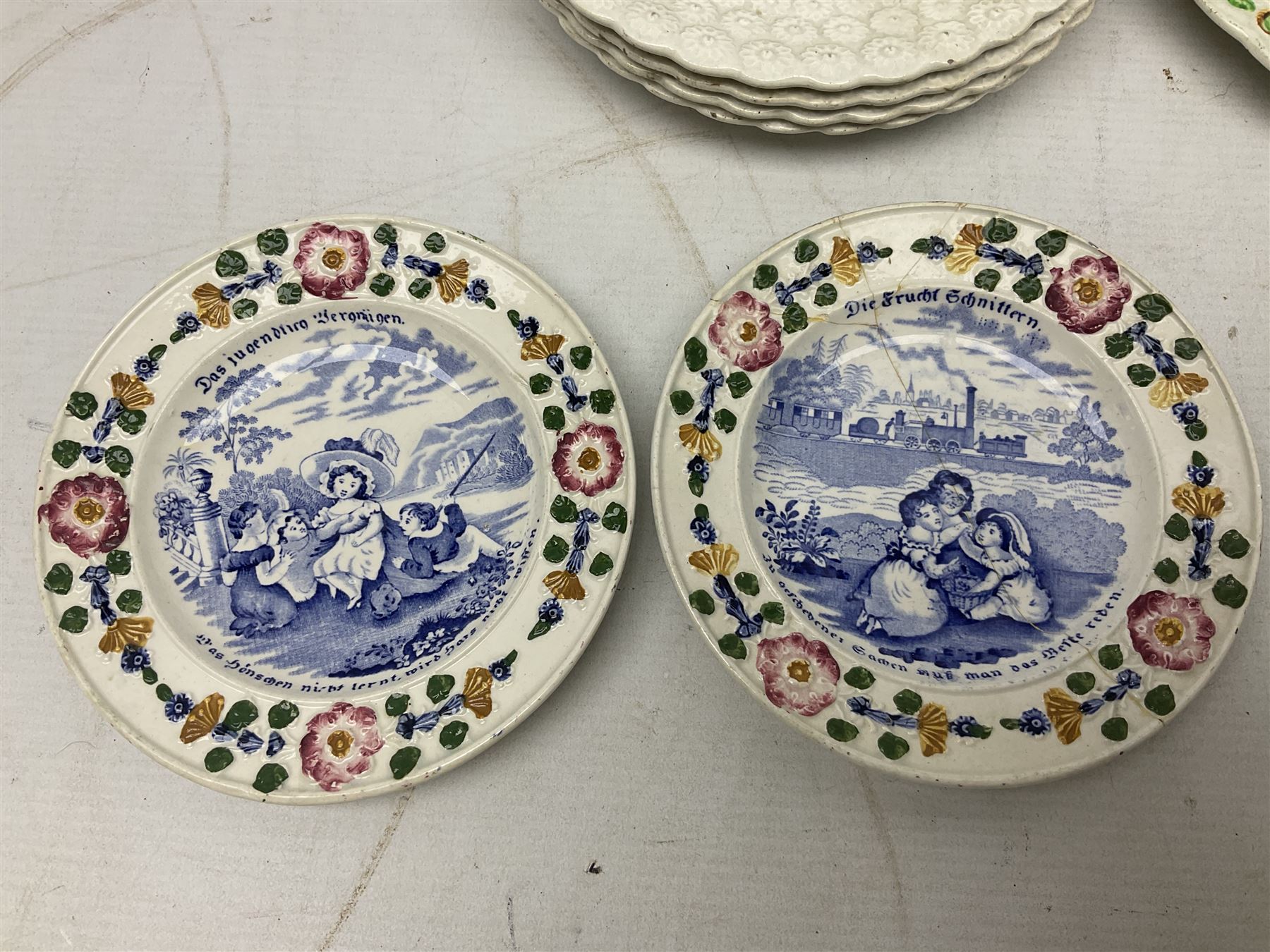 Collection of 19th century William Smith & Co nursery plates, to include examples decorated in the pastime series, and similar, all with moulded floral borders