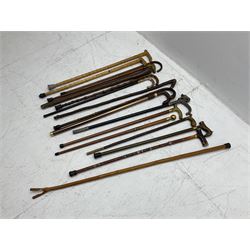 Collection of walking sticks, to include a a modern hidden umbrella stick, wooden pommel example inscribed 1910, two collapsible examples and a thumb stick, etc