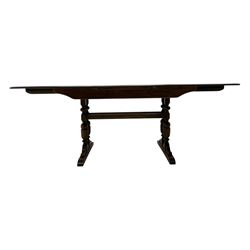 Ercol - late 20th century oak refectory dining table, rectangular top with rounded corners and central extending leaf, raised on turned baluster supports united by a stretcher (Extended 200cm)