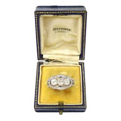 Late 19th / early 20th century platinum diamond ring, three old cut diamonds, in an openwork setting surrounded by further old cut diamonds, with pierced design shoulders, principal three diamonds total weight approx 1.45 carat, in a velvet and silk lined box by Selfridges