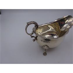 Early 20th century silver sauce boat, of typical form with shaped rim and acanthus capped flying C scroll handle, upon three palmette mounted hoof feet, hallmarked Thomas Edward Atkins, Birmingham 1915, including handle H8.5cm
