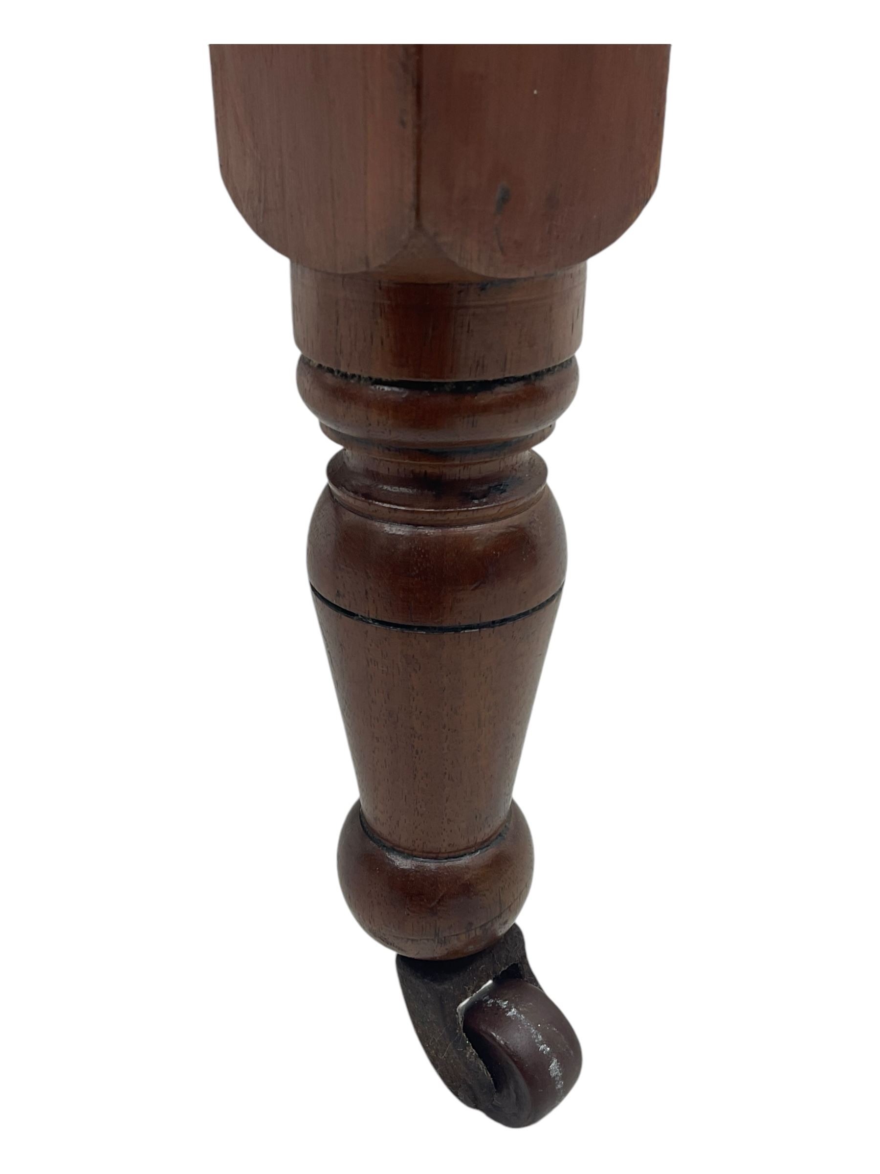 Victorian oak occasional table, octagonal top with bevelled edges, lower section fitted with a square undertier united by decorative shaped stretchers, on turned supports with castors