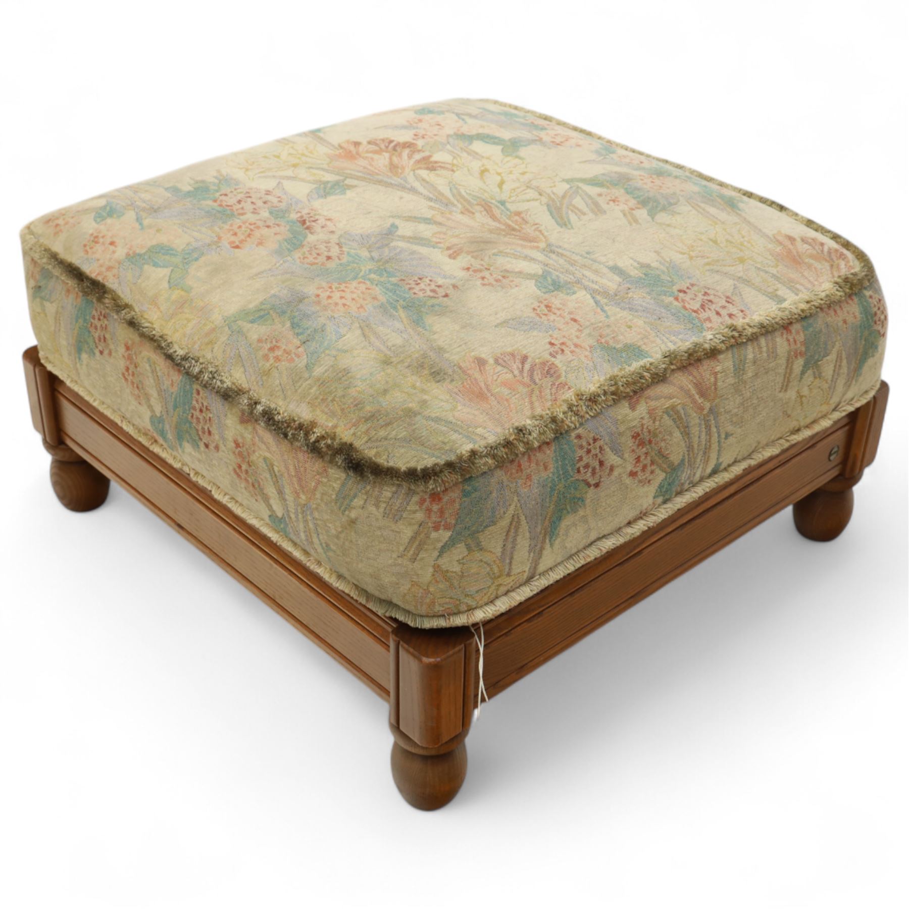 Ercol – bergère four piece suite, including armchair, two seat sofa, three seat sofa and footstool, all with removable floral upholstered cushions, the frames with side caning and rounded arm supports in stained beech

Three seat (H 87cm, D 89cm, W 196cm)
Two seat (H 87cm, D 89cm, W 137cm)
Armchair (H 87cm, D 89cm, W 87cm)
Footstool (H 28cm, D 55cm, W 55cm)