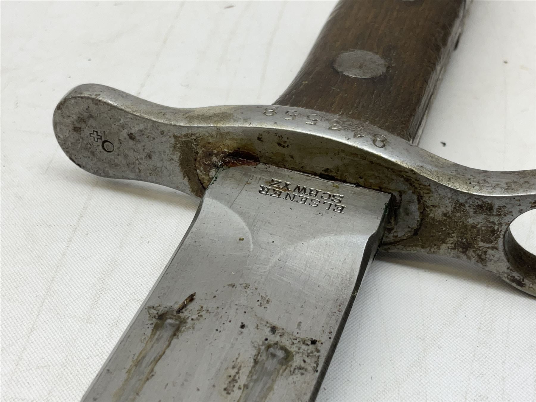 Schmidt-Rubin Model 1918 bayonet, the 30cm steel blade marked Elsener Schwyz, cross-piece numbered 813558; in steel scabbard with leather frog stamped E. Banga Sattler Selzac 67 L45.5cm overall; and Swiss Model 1957 SIG rifle bayonet by Wenger; in plastic scabbard with leather frog stamped E. Walty Sattlerei Baretswil 84 (2)