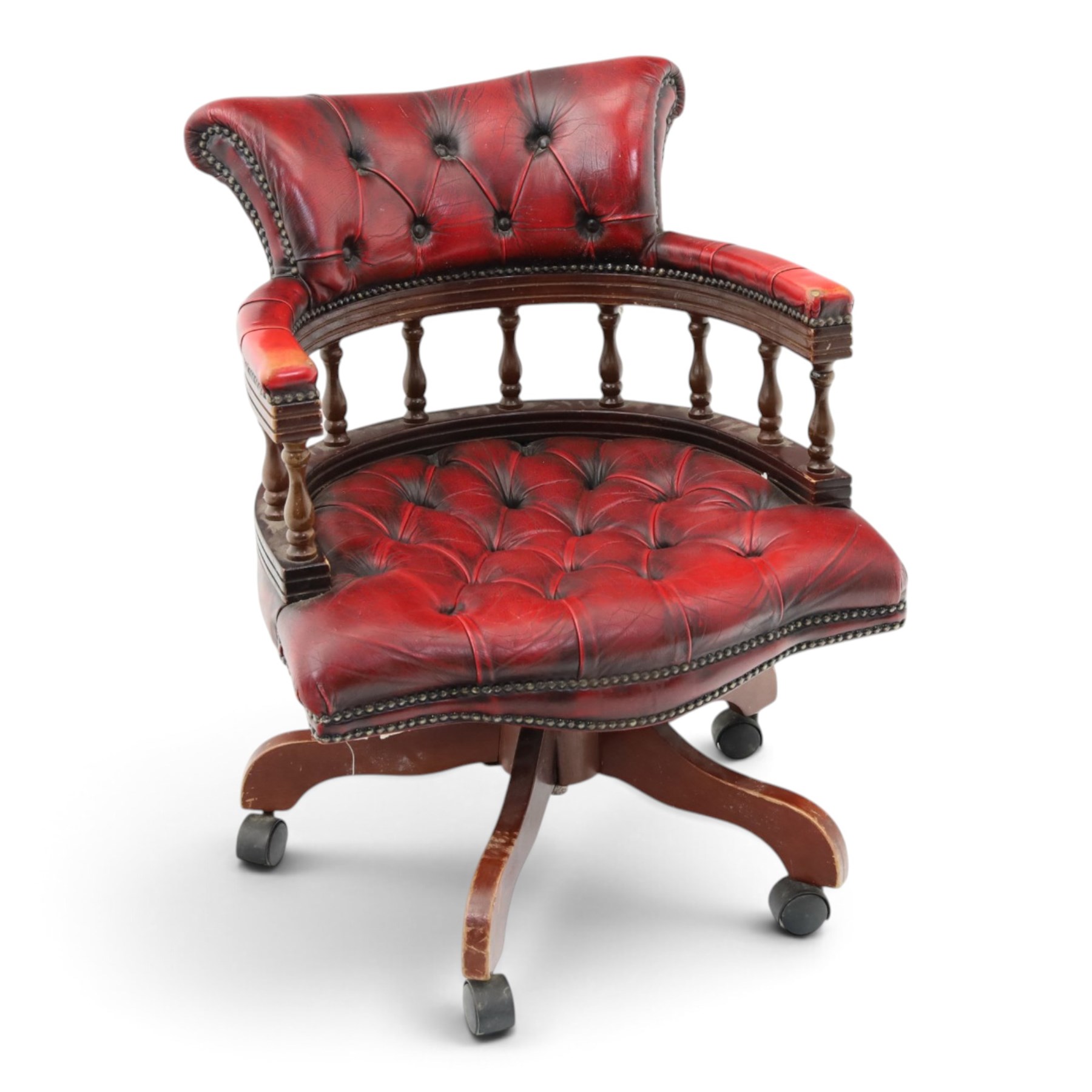Georgian design captains swivel desk chair, rolled cresting rail over open spindle back on swivel action, upholstered in buttoned oxblood leather