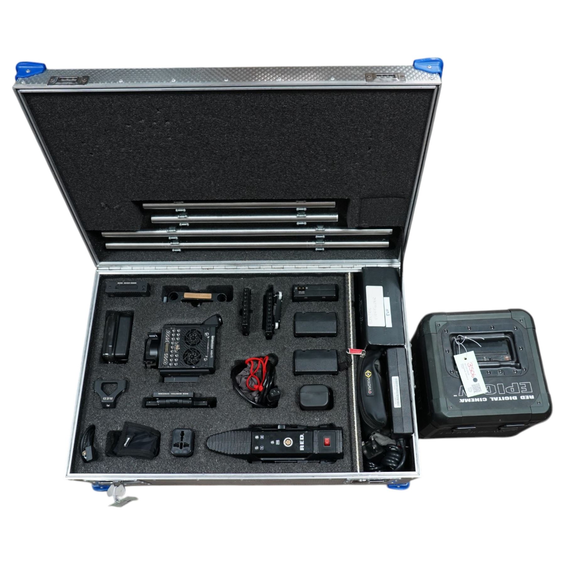 RED Epic-W Helium 8K camera body serial no. 13024E6A9, with RED EVF, three RED Mini Mag 512GB cards, one 480 Mini Mag card and reader, two RED V-Mount batteries and charger, RED top handle, Wooden Camera Easy Top top plate and one other top plate, various accessory cables, Wooden Camera bridge plate for 19mm studio rods, 12 inch Wooden Camera Dovetail plate and four 19mm studio rods to include two 380mm and two 610mm, with original Epic-W camera box and contained within a custom cut flight case