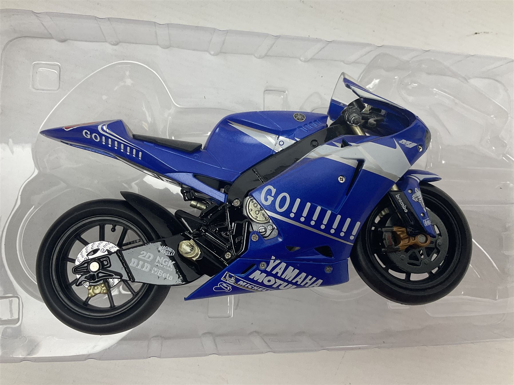 Three Minichamps 1:12 scale die-cast models of motorcycles - Suzuki GSX-R1000 Team Alstare Suzuki Corona Extra Troy Corser WSB 2005; Yamaha YZR-M1 Gauloises Yamaha Team Colin Edwards MotoGP Laguna Seca 2005; and Honda NSR 500 Loris Capirossi MotoGP 2002; all boxed (3)