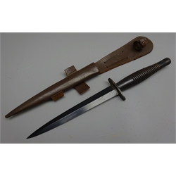  Three wooden handled Commando Knives, 17cm twin edged blued steel blade with ribbed grip, L29.5cm, another two similar knives, all in leather scabbards (3)  