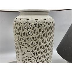 Two 20th century Blanc de Chine ceramic vases converted to table lamps, the taller cylindrical and smaller baluster shaped pierced bodies decorated with blossoming branches and grey fabric shades, tallest H64cm incl shade