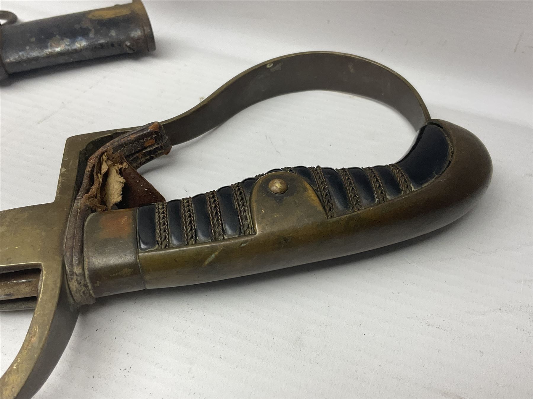 Prussian artillery officer's sword, with 80cm slightly curving fullered  blade, brass hilt with D-shaped langets, curving knucklebow, wire-bound black grip and leather finger loop; in black painted steel scabbard with single suspension loop