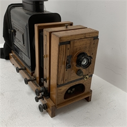 Very large oak and brass magic lantern style enlarger, the black japanned lamp housing with embossed Ernemann Dresden plaque, rack and pinion focusing, two folding bellows, rise-and-fall and pivoting facilities and Ross London 5