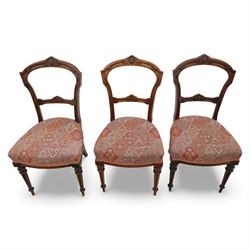 Set of six late Victorian mahogany dining chairs, the shaped top rails carved with anthemion motifs, above pierced splats, floral and geometric fabric seat, on turned and fluted front legs
