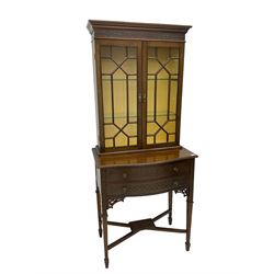 Early 20th century mahogany display cabinet on stand,  the cabinet enclosed by two astragal glazed doors, shaped stand fitted with two drawers on square tapering supports with spade feet