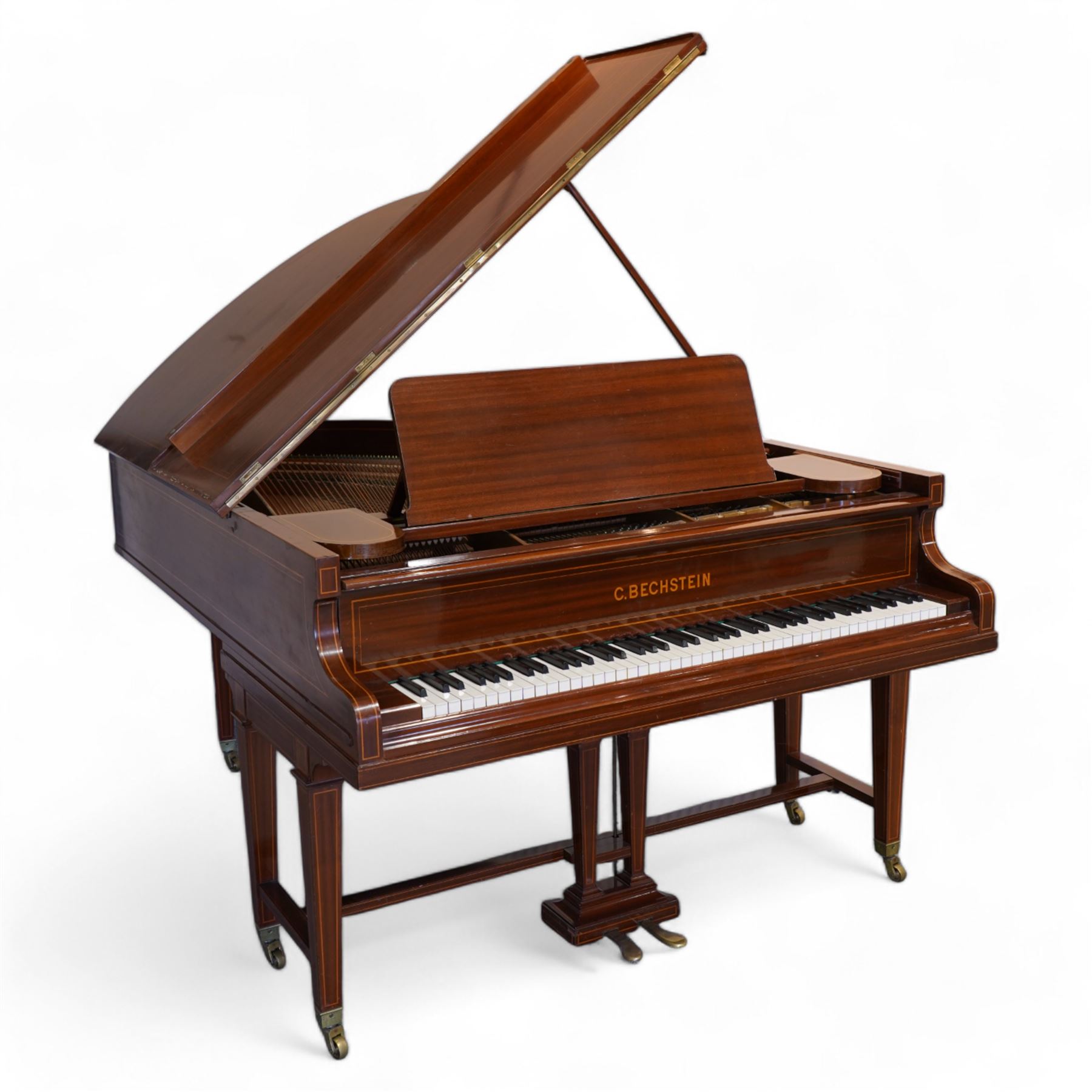 Carl Bechstein model A  grand piano serial No 44945 (1898), in a Sheraton revival mahogany case with inlaid satinwood stringing, overstrung cast iron frame raised on dual square tapering legs with brass castors, solid music desk and conforming lyre, 85 note (7 octave) A-A compass, sostenuto and sustain pedals, original action, hammers, dampers and stringing.

This item has been registered for sale under Section 10 of the APHA Ivory Act