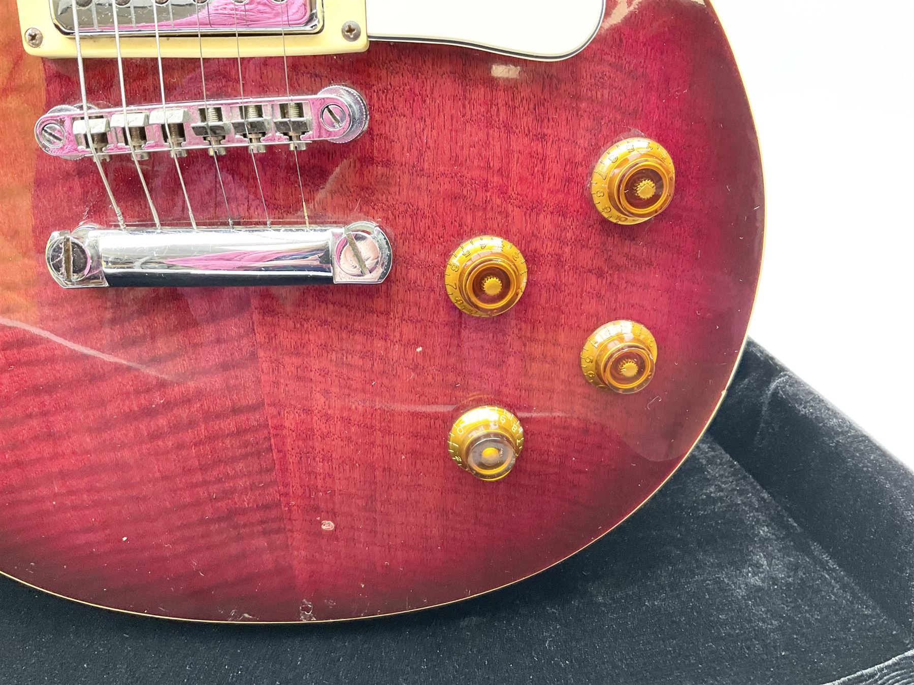 1980s Les Paul Epiphone limited edition cut-away electric guitar by Gibson, the burgundy coloured body with two pick-ups, volume and tone knobs and scratch plate, original tuning pegs, serial no.U6030215, 101cm overall; in modern Kinsman fitted carrying case