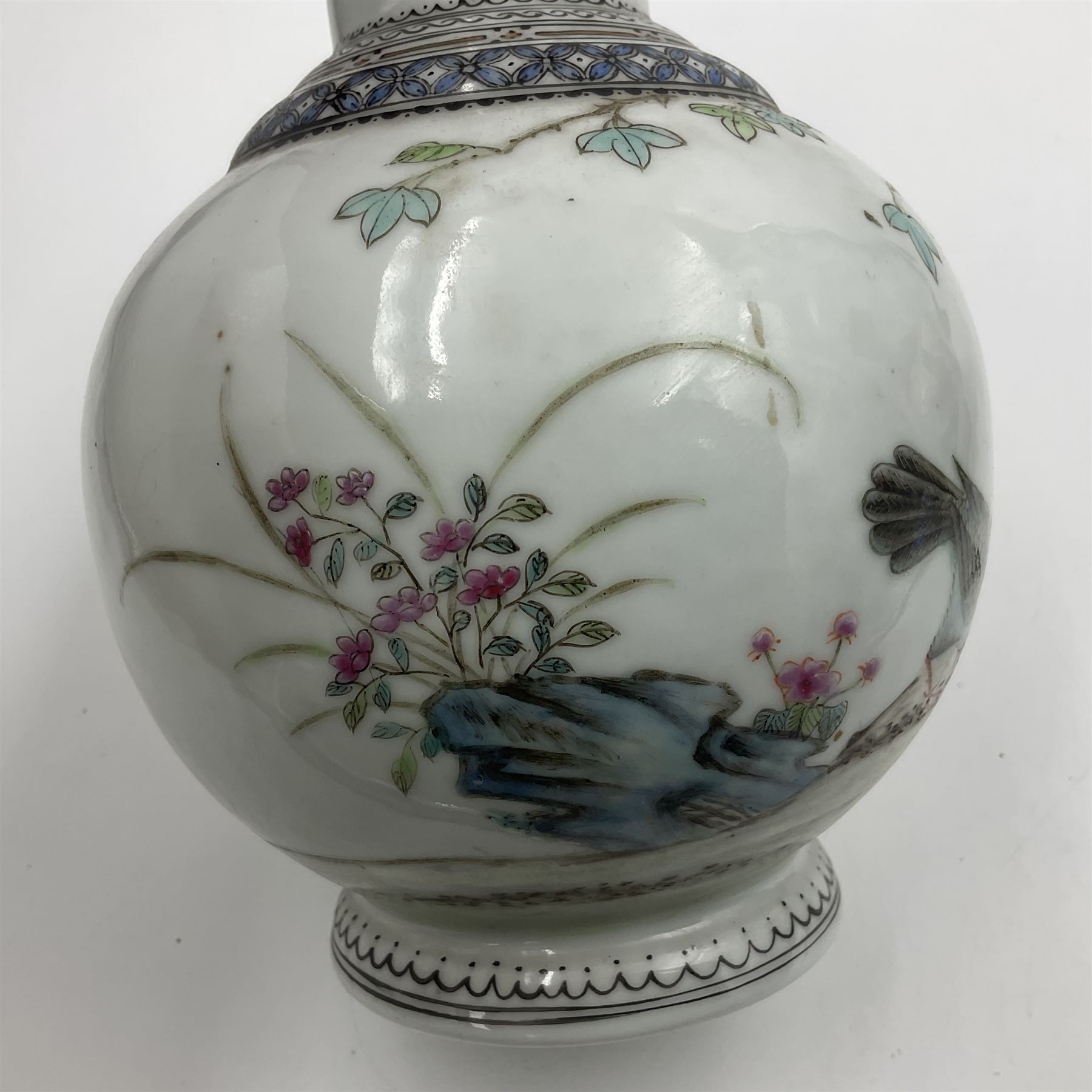 Pair of Chinese Republic porcelain vases, each painted in Famille Rose enamels with pairs of pigeons amidst peony, rock, flowering plants and leafy branches, possibly Qianlong seal beneath, H22cm 