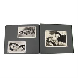 Collection of photographs and postcards, mostly depicting 1940s film stars, including some autographed examples and some with printed signatures, together with a collection of Shirley Temple  promotional photographs,1930s autograph album and postcards of the Royal Family