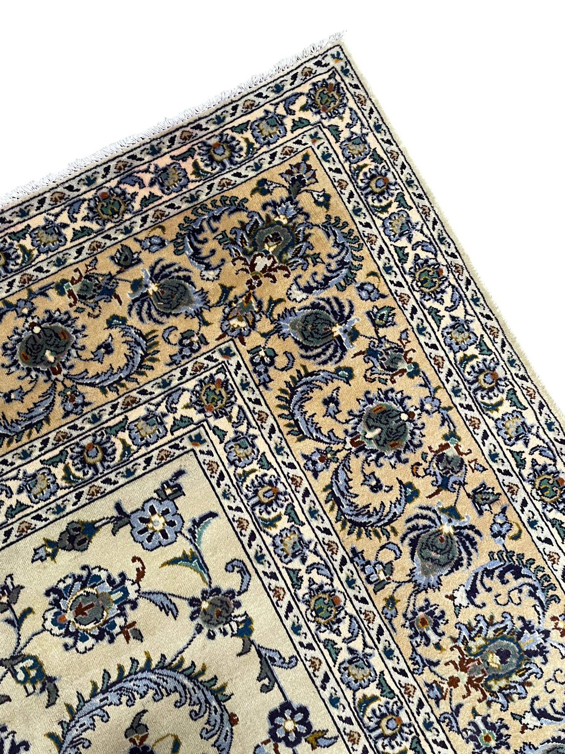 Persian Nain pale sage ground carpet, decorated with curled leaf motifs and palmettes, the busy borders decorated densely with similar design, within floral pattern guard stripes 