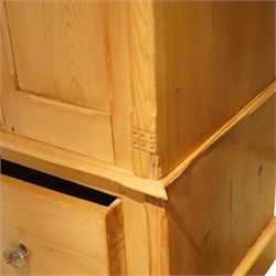 Victorian waxed pine wardrobe, carved projecting cornice with mirrored door, enclosing clothes hooks and rail, above a single drawer with glass knobs