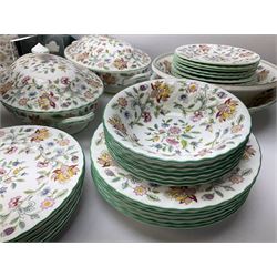 Minton Haddon Hall pattern tea and dinner wares, including basket dish, two covered tureens, six dinner plates, eight dessert plates, twelve tea plates, six soup bowls, six cereal bowls, teapot, coffee pot, milk jug, covered sucrier twelve tea cups and saucers, six mugs, footed bon bon dish, pair of candlestick holders, cake knife and slice etc (81)