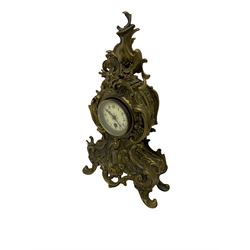 A tall gilt metal mantle clock in a rococo style case c1900, with a French spring driven single train timepiece movement and recoil anchor escapement, cream enamel dial with upright Arabic numerals, minute markers and steel fleur de Lis hands, brass bezel with a flat bevelled glass. With pendulum.



