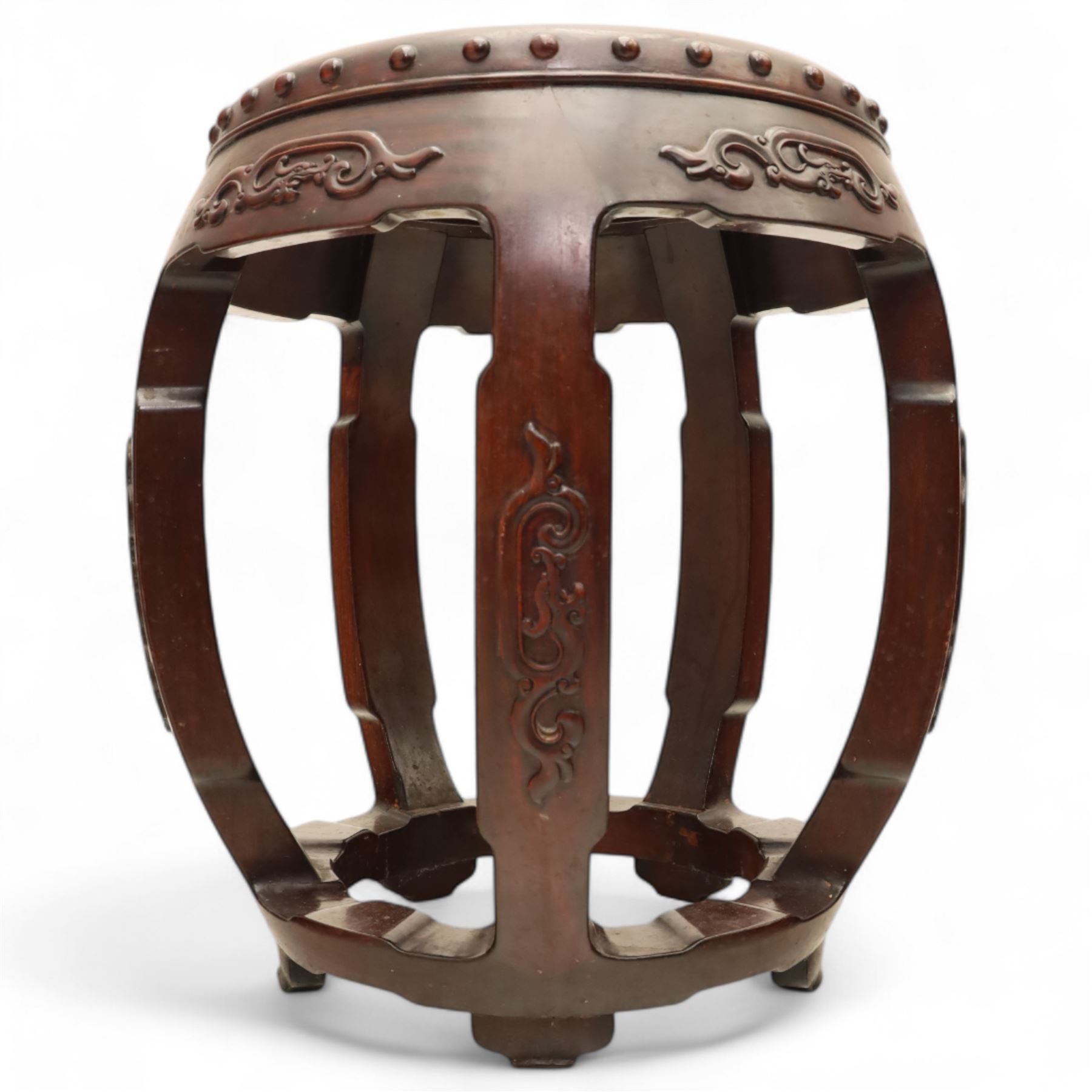 Pair of early 20th century Oriental hardwood barrel seats, of drum form with shaped apron and pierced panels, carved with stylised scrollwork and studded detail to the top