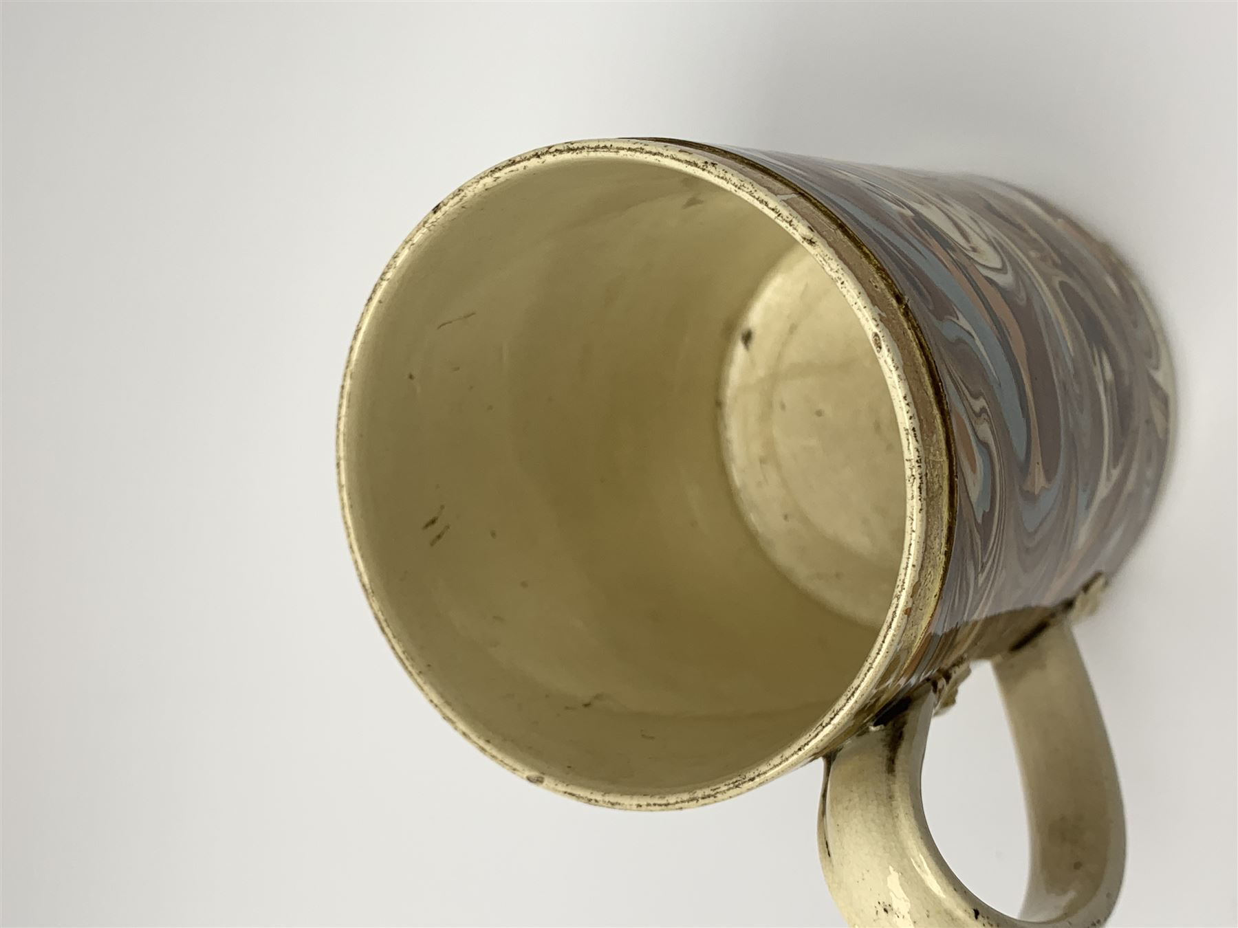 Late 18th century earthenware mug, possibly Ralph Wedgwood, Burslem or Ferrybridge, with surface marbled decoration and later gilt detail to rims and handle, impressed beneath Wedgwood & Co, H12cm