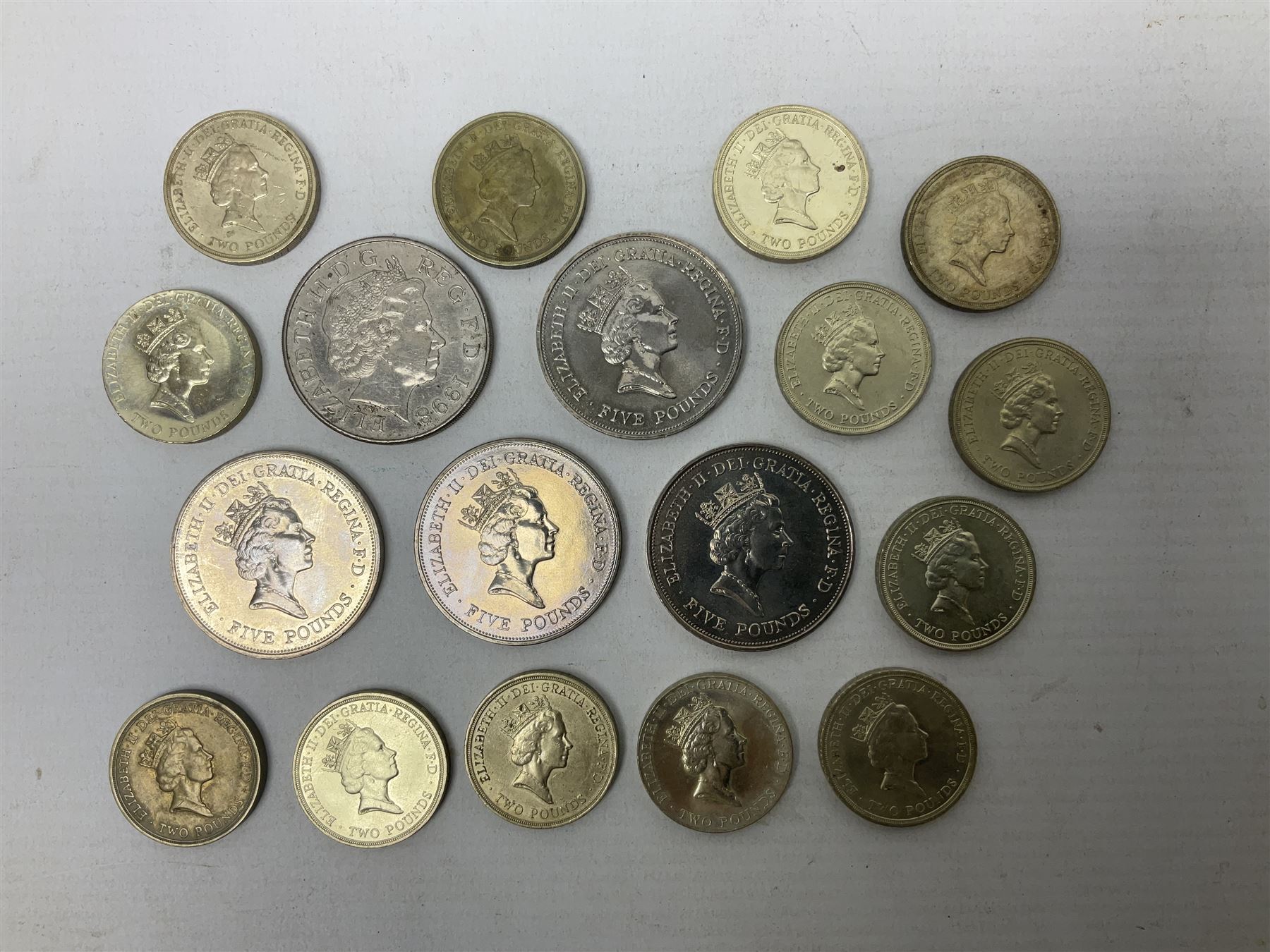 Five Queen Elizabeth II five pound coins and thirteen old style two pound coin