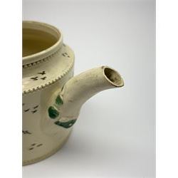 18th century creamware teapot, probably Leeds, with reeded entwined handle and floral finial to the cover, the body with hand painted polychrome decoration of figure to one side, and floral spray to the other, collectors paper label beneath inscribed Leeds Pottery, H11.5cm