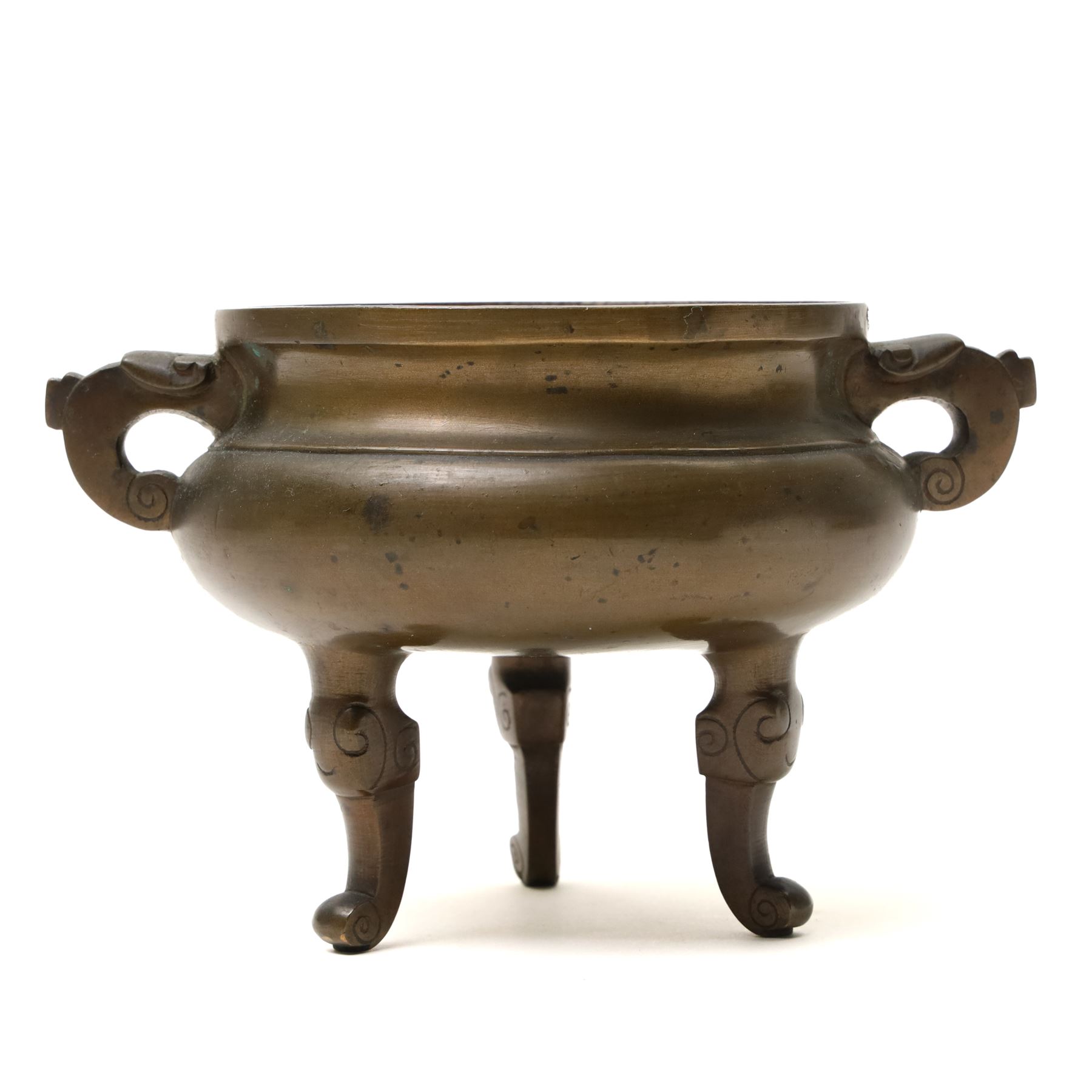 19th century Chinese bronze censer with loop handles and on shaped supports D13cm and an Asian bronze bell H17cm