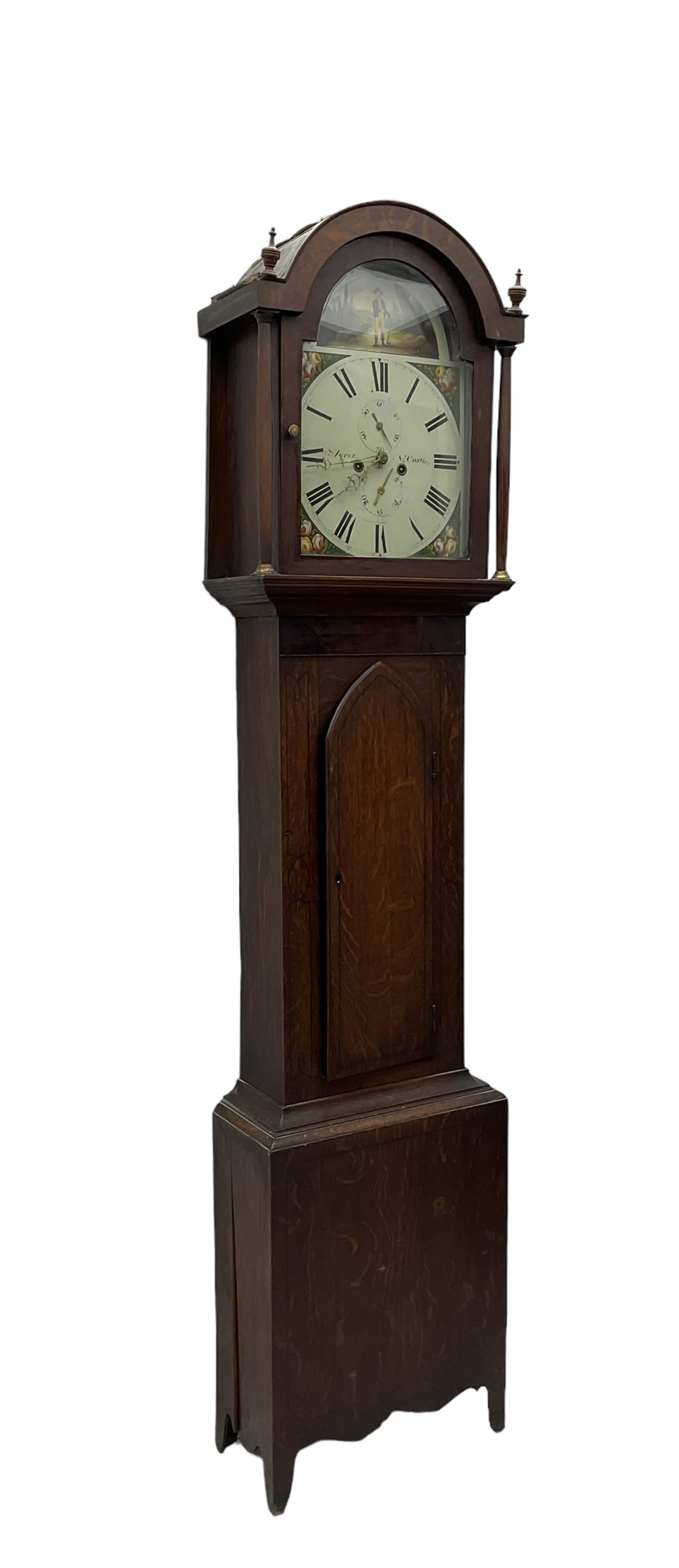 Ayers of Newcastle - 19th century oak cased 8 day longcase clock c1850, with a break-arch top and turned wooden finials, conforming hood door flanked by waisted pilasters and brass capitals, trunk door with an arched top, rectangular plinth with decorative base, painted dial with floral spandrels and a rural depiction to the arch, Roman numerals and minute track, with matching brass hands and subsidiary seconds and date dials, dial pinned directly to a rack striking movement, sounding the hours on a bell. With pendulum and weights.