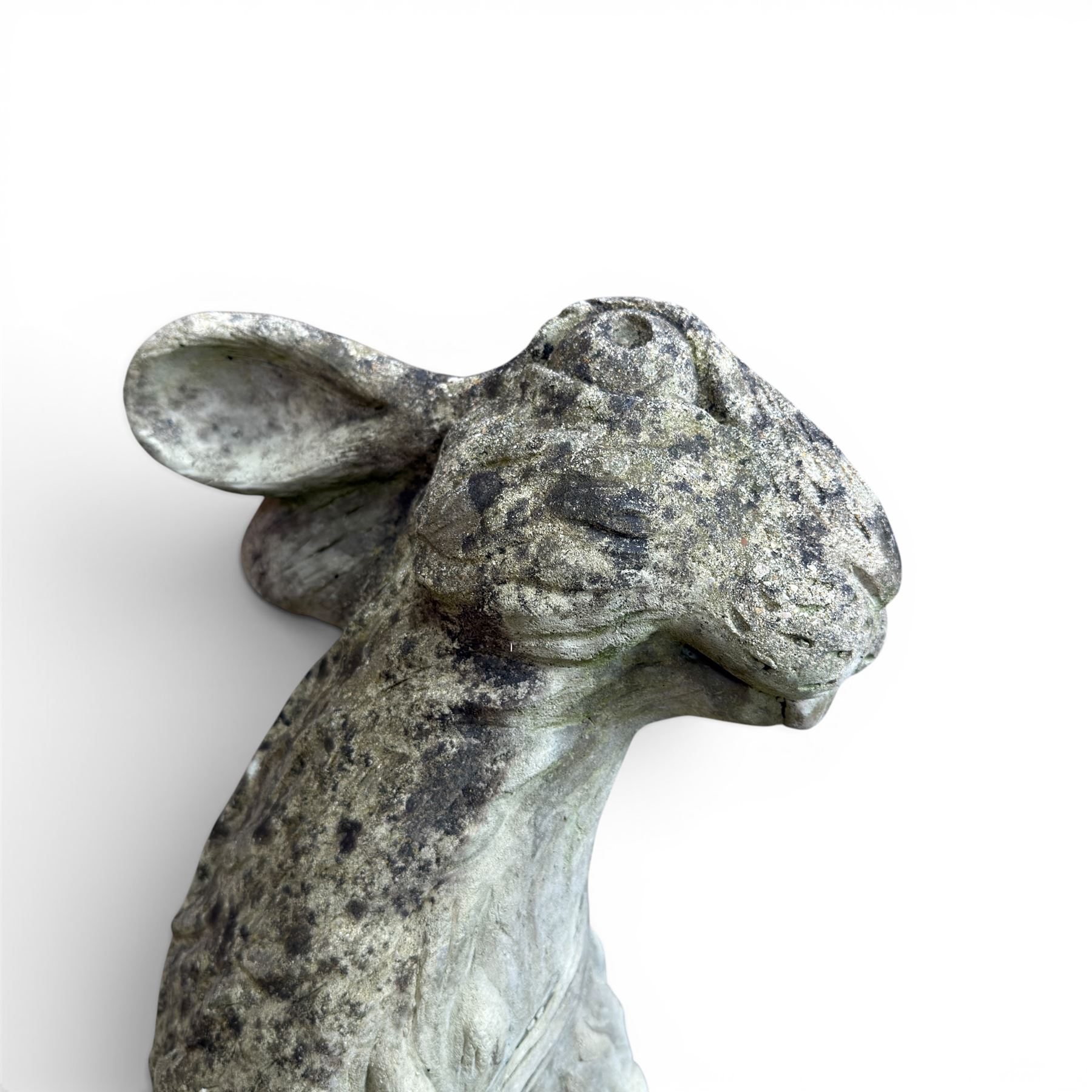 Two weathered cast stone garden hares