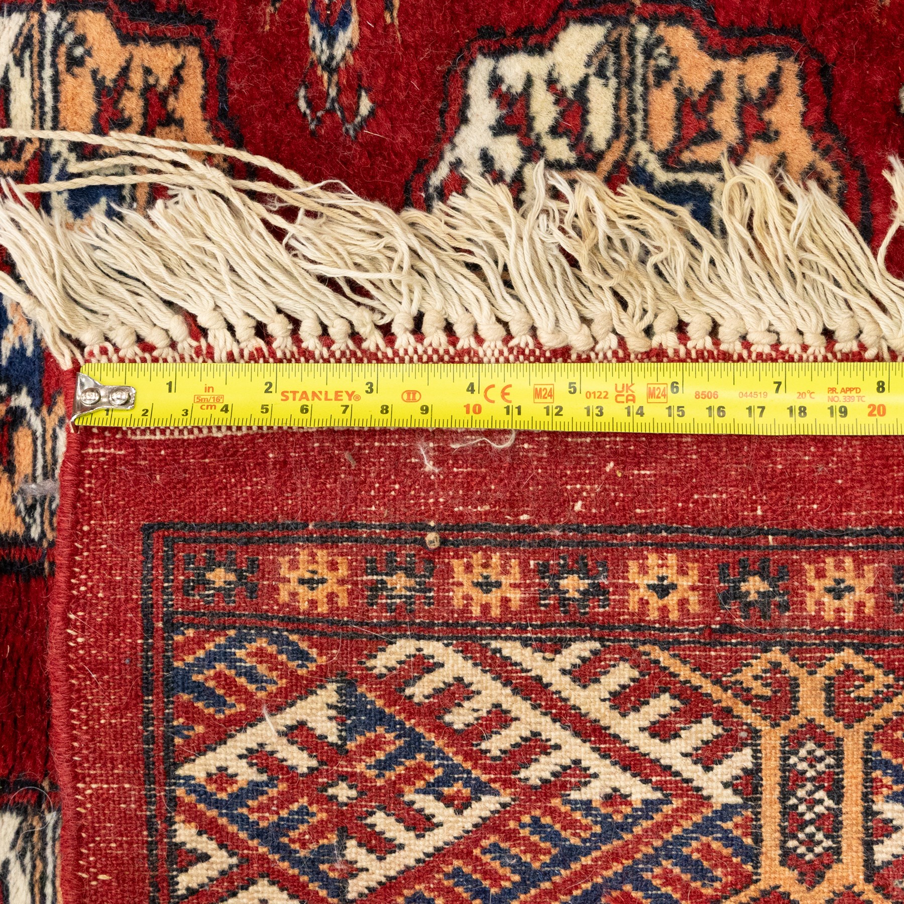 Two hand-knotted rugs, comprising Persian floral rug, dark blue ground decorated with scrolling foliage and flowerheads within a red floral border (H 208cm, W 134cm); Bokhara type rug, red ground with repeating gul motifs and geometric guard borders (H 174cm, W 94cm)
