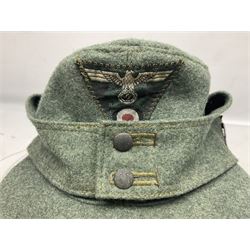 WW2 German Army M43 field cap with triangular cloth eagle and roundel badge and metal edelweiss badge for mountain troops; faintly stamped '5 VMF(?)'