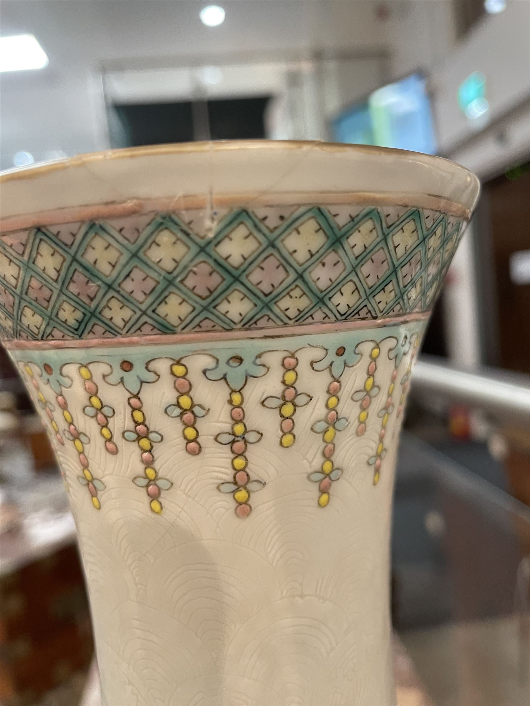Pair 20th century Chinese famille verte bottle vases, each decorated with green and purple dragons chasing pearls amidst auspicious flames, the neck with yellow and green stylised foliate and cell borders, and the white glazed body incised throughout with fan shapes, each with red character mark beneath flanked by green dragons, H38cm

