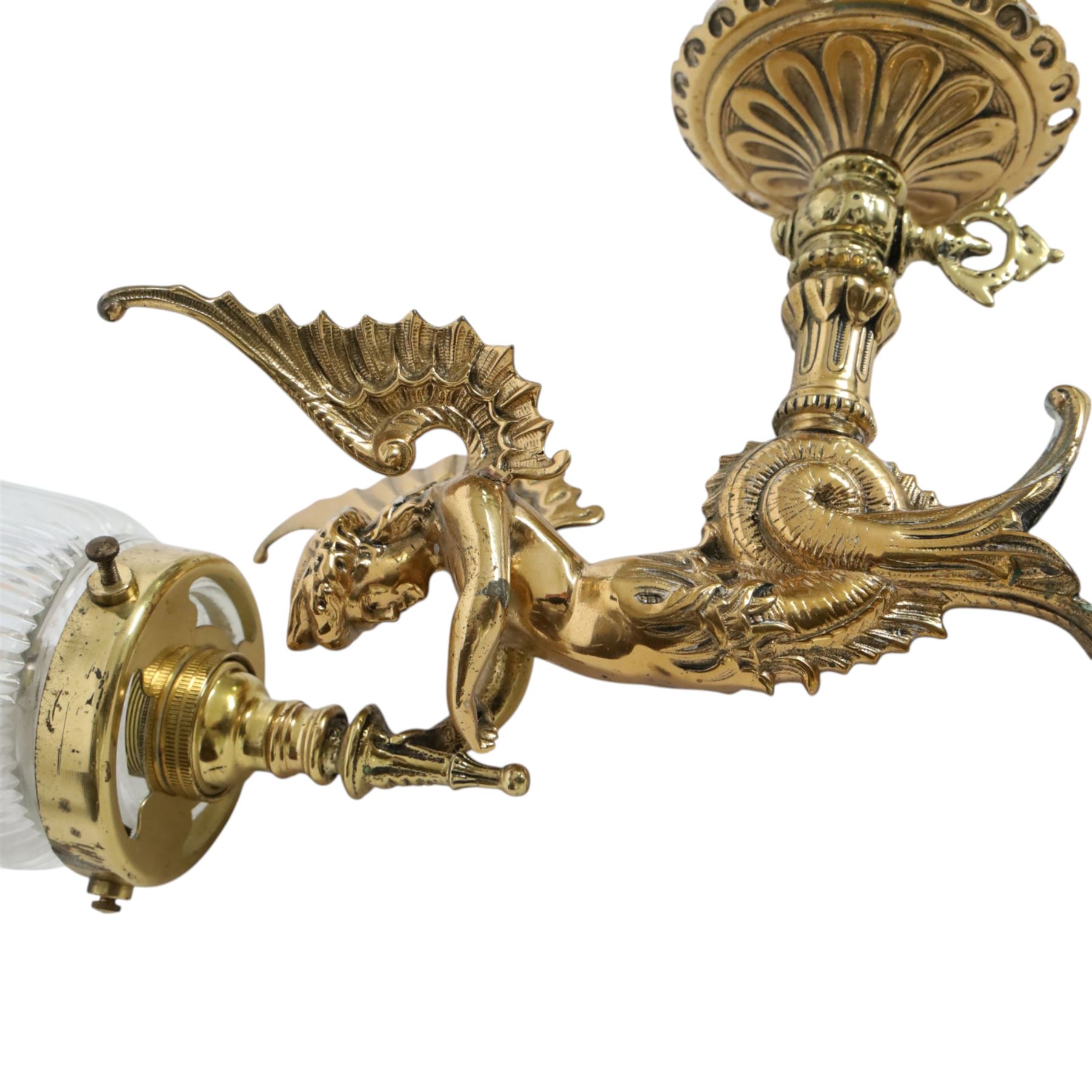 Pair of Victorian style wall sconces, each modelled as a caryatid supporting a single light fitting in one raised arm, with tapering and fluted clear glass shade, approximately H31cm D21cm