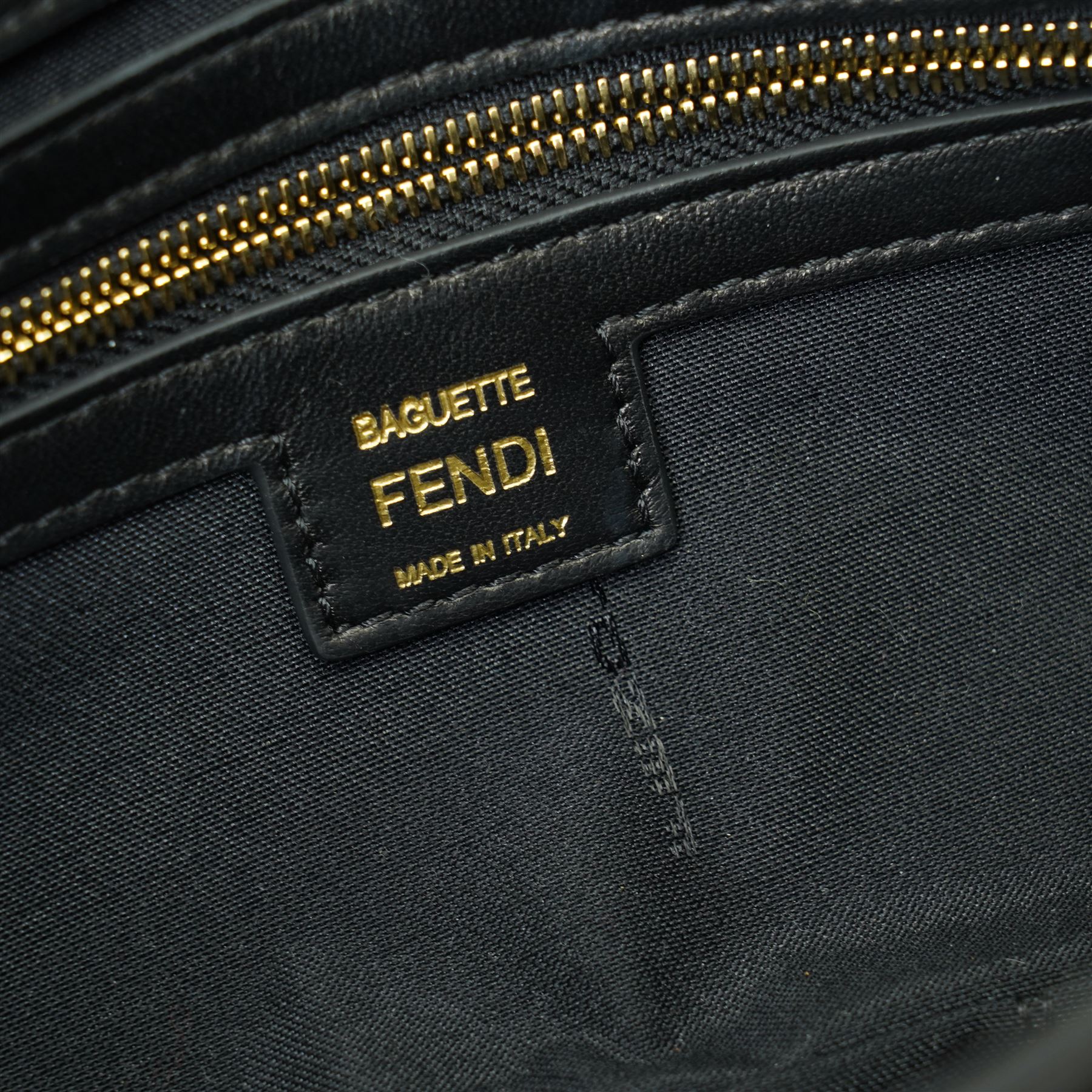 Fendi Baguette shoulder bag, black nappa leather with embossed FF monogram and quilted panels, the front flap secured by a gold-tone FF logo magnetic clasp engraved Fendi Made in Italy, with detachable leather shoulder strap and gold-tone hardware, interior leather tab stamped 'Baguette Fendi Made in Italy', together with original Fendi dust bag and box, W27cm D7cm H15cm