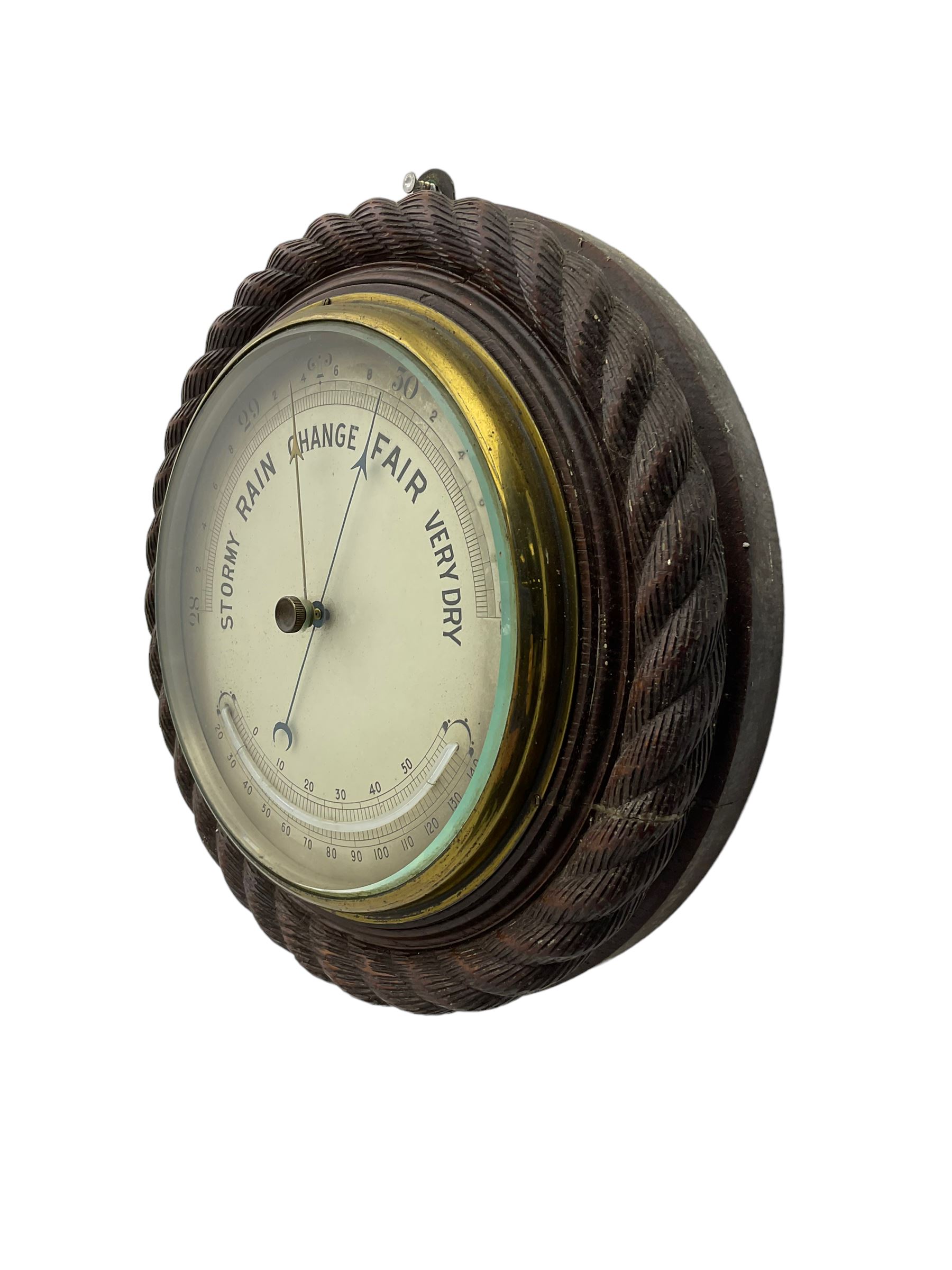 Edwardian - 8-day ships bulkhead clock and an Aneroid barometer.
In matching circular oak cases with carved rope twist bezels.
Clock with a painted metal dial, Roman numerals, minute track and steel spade hands, small seconds hand and platform regulation. Case 9