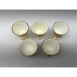 19th century tea wares, comprising milk jug, cream jug, lidded sucrier, three breakfast cups, two teacups and one coffee cup, four larger saucers, two smaller saucers, four side plates, and five egg cups, each decorated with peach borders and heightened in gilt, a number of pieces marked beneath with pattern no 939. 