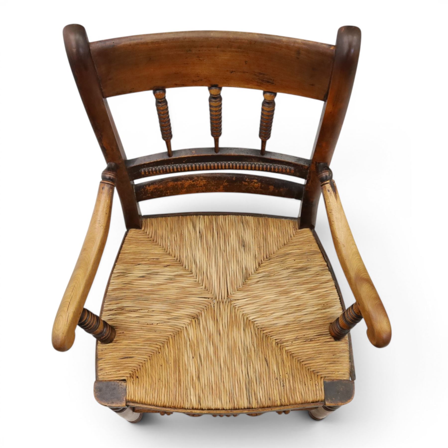 19th century elm chair, with curved top rail and bobbin turned spindles, woven rush seat, on turned legs united by front stretcher