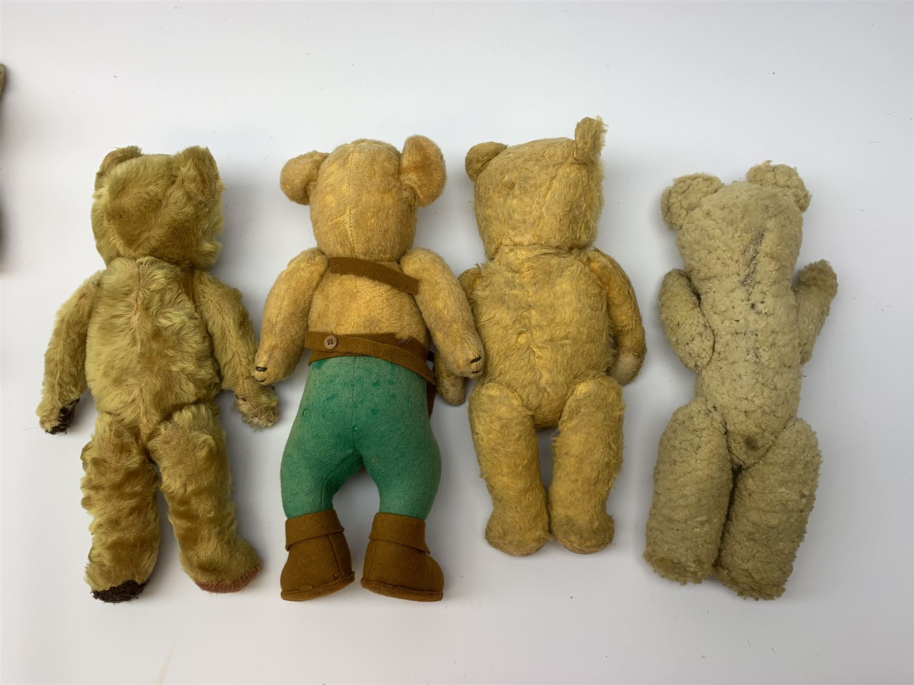 Nine English teddy bears 1950s-60s including wood wool filled Pedigree bear with swivel jointed head, glass eyes, vertically stitched nose and mouth and jointed limbs H14.5
